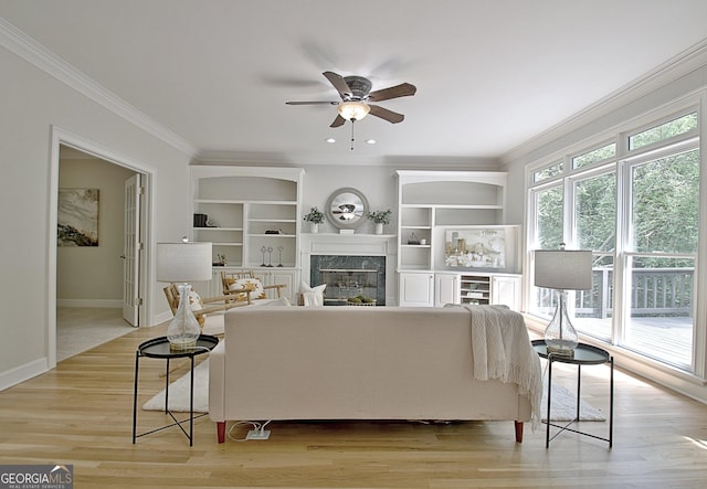 112 Windalier Rdg, Peachtree City, GA 30269 - living area with crown molding, a ceiling fan, a high end fireplace, light wood-type flooring, and baseboards