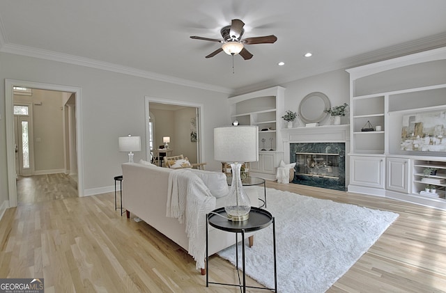 112 Windalier Rdg, Peachtree City, GA 30269 - living room with crown molding, a ceiling fan, light wood-style floors, a fireplace, and baseboards