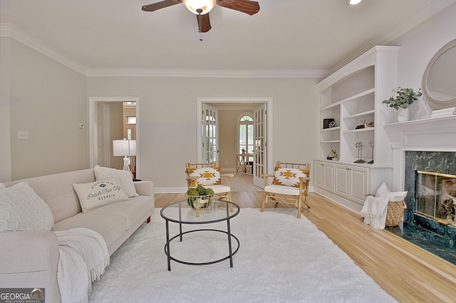 112 Windalier Rdg, Peachtree City, GA 30269 - living area featuring crown molding, light wood-type flooring, a ceiling fan, a premium fireplace, and baseboards