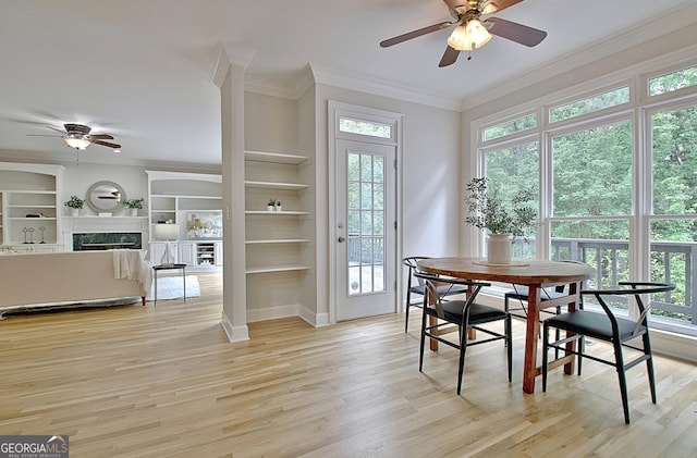 112 Windalier Rdg, Peachtree City, GA 30269 - dining space featuring a ceiling fan, healthy amount of natural light, ornamental molding, and a premium fireplace