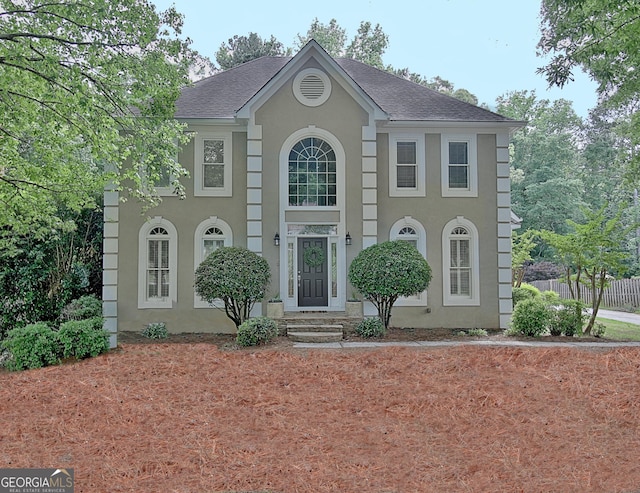 112 Windalier Rdg, Peachtree City, GA 30269 - colonial home featuring stucco siding, roof with shingles, and fence