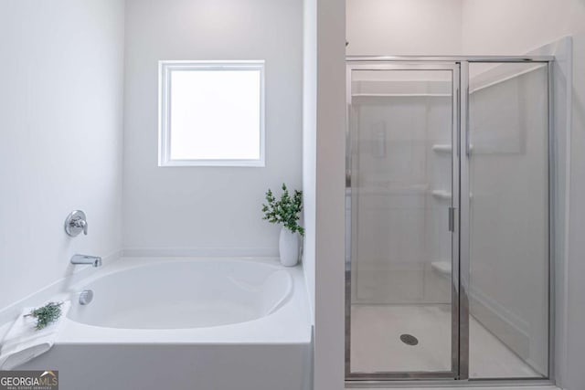 full bath with a shower stall and a bath