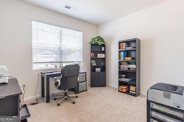 carpeted home office featuring baseboards