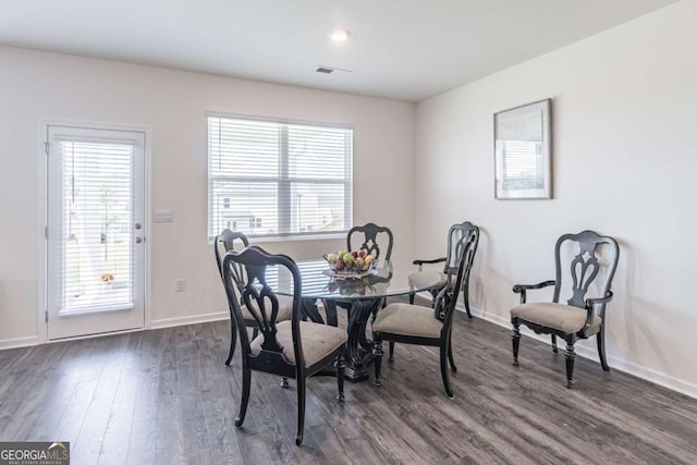 dining area with dark wood-style floors and baseboards