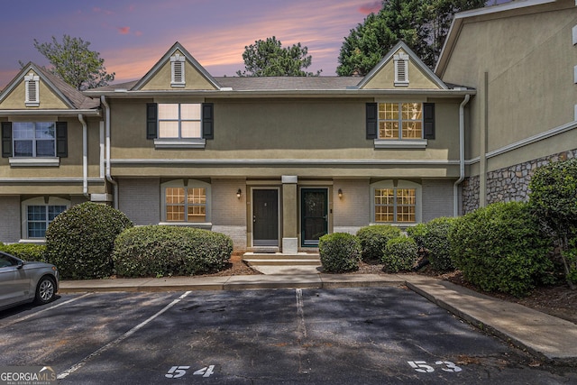 6900 Roswell Rd Unit F6, Atlanta, GA 30328 - view of front of property with stucco siding, uncovered parking, and brick siding