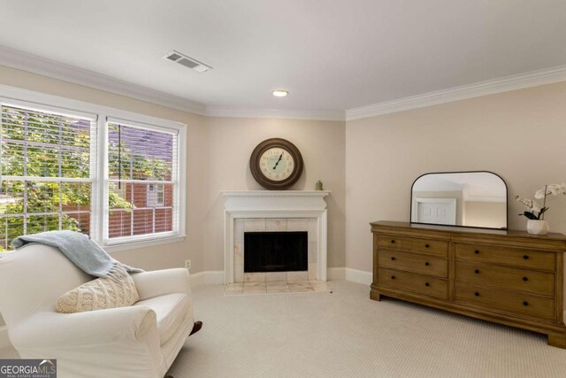 sitting room featuring ornamental molding, a tile fireplace, carpet floors, and baseboards