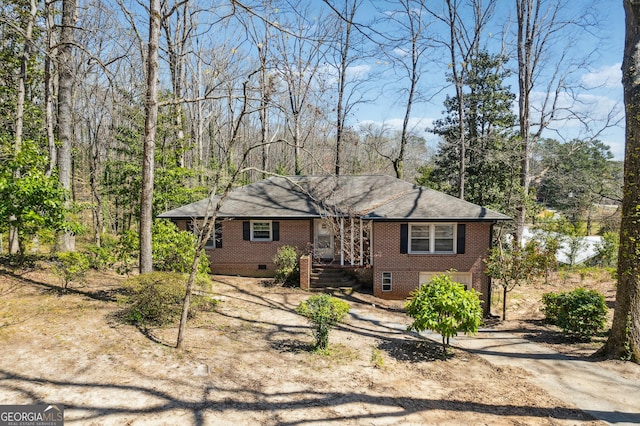 ranch-style home with driveway, brick siding, crawl space, and a shingled roof