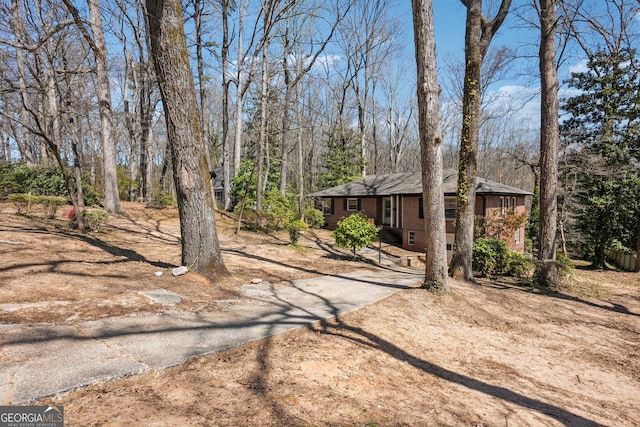 view of yard with asphalt driveway