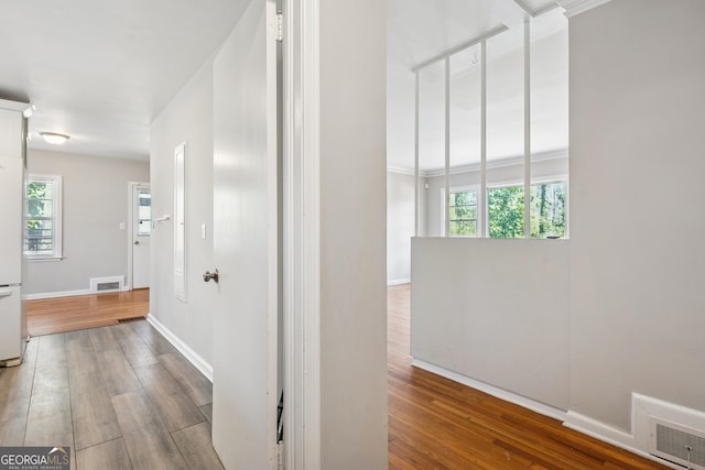 hallway with wood finished floors and baseboards