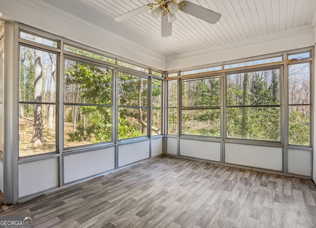 unfurnished sunroom with ceiling fan