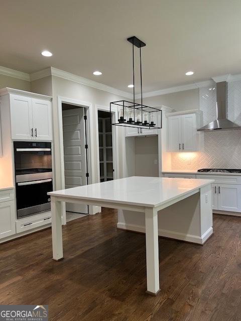 5907 SW Bunting Ln SW Unit 2, Atlanta, GA 30331 - kitchen featuring wall chimney range hood, stainless steel double oven, crown molding, white cabinets, and recessed lighting