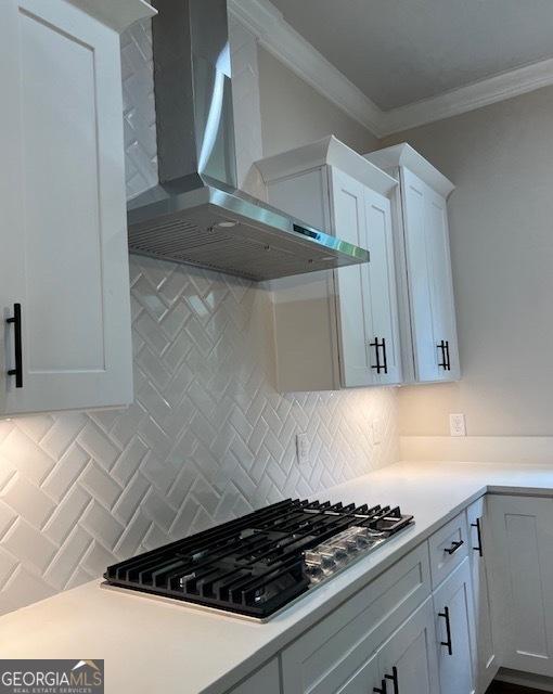 5907 SW Bunting Ln SW Unit 2, Atlanta, GA 30331 - kitchen featuring wall chimney exhaust hood, stainless steel gas stovetop, decorative backsplash, crown molding, and light countertops