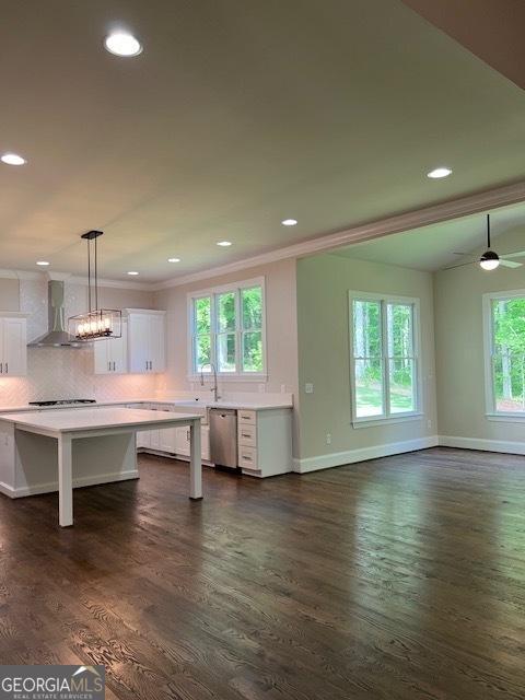 5907 SW Bunting Ln SW Unit 2, Atlanta, GA 30331 - kitchen with wall chimney exhaust hood, stainless steel dishwasher, white cabinetry, baseboards, and stovetop