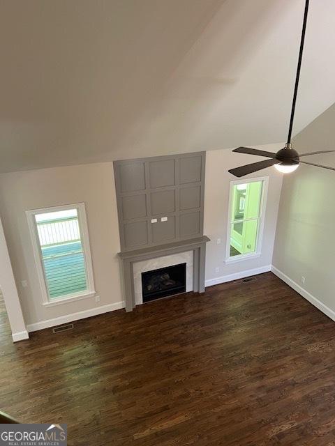 5907 SW Bunting Ln SW Unit 2, Atlanta, GA 30331 - unfurnished living room with dark wood finished floors, baseboards, vaulted ceiling, a large fireplace, and a ceiling fan