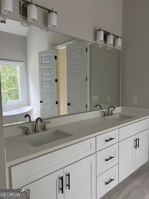 5907 SW Bunting Ln SW Unit 2, Atlanta, GA 30331 - full bathroom featuring double vanity and a freestanding tub