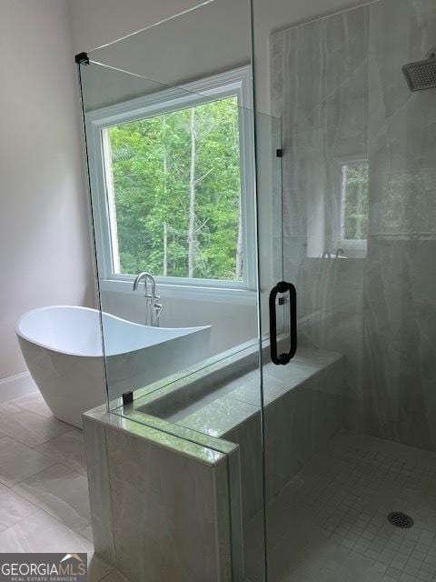 5907 SW Bunting Ln SW Unit 2, Atlanta, GA 30331 - bathroom featuring a shower stall, a soaking tub, and baseboards