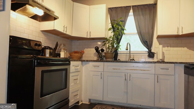 288 Harper Rd SE, Atlanta, GA 30315 - kitchen with appliances with stainless steel finishes, under cabinet range hood, white cabinets, and dark stone countertops