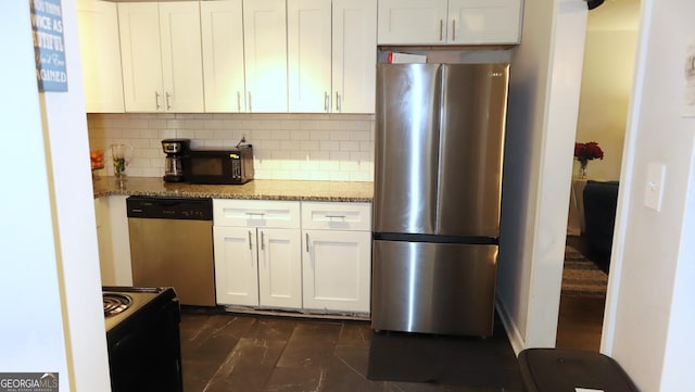 288 Harper Rd SE, Atlanta, GA 30315 - kitchen with black appliances, white cabinets, backsplash, and light stone counters