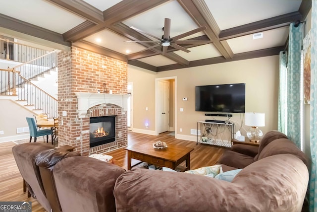 663 Warm Springs Ct, Loganville, GA 30052 - living area with wood finished floors, a ceiling fan, beamed ceiling, coffered ceiling, and stairs