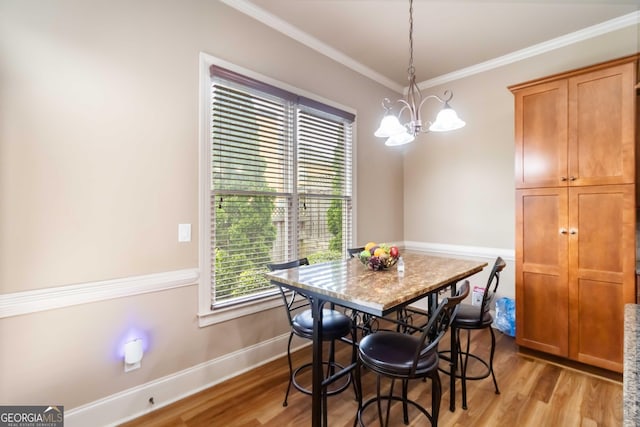 663 Warm Springs Ct, Loganville, GA 30052 - dining room with a chandelier, light wood-style flooring, and crown molding
