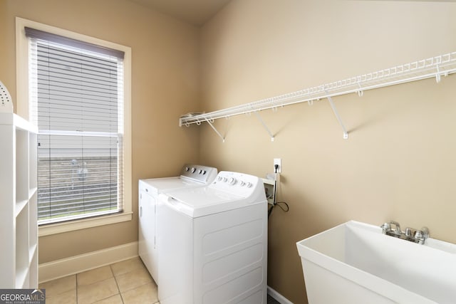 663 Warm Springs Ct, Loganville, GA 30052 - laundry area with washer and clothes dryer and light tile patterned flooring