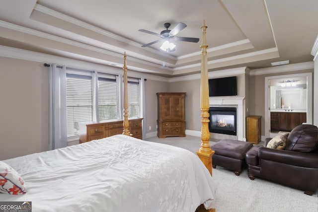 663 Warm Springs Ct, Loganville, GA 30052 - carpeted bedroom featuring a raised ceiling, a multi sided fireplace, ornamental molding, and a ceiling fan