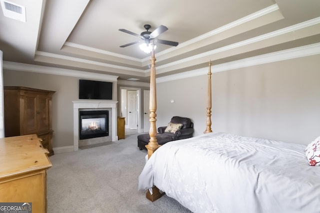 663 Warm Springs Ct, Loganville, GA 30052 - bedroom with a raised ceiling, carpet flooring, a fireplace with flush hearth, ornamental molding, and ceiling fan