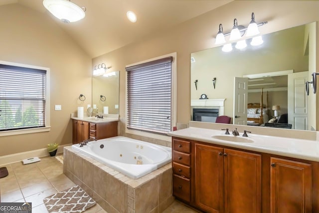 663 Warm Springs Ct, Loganville, GA 30052 - bathroom with a jetted tub, two vanities, lofted ceiling, ensuite bath, and tile patterned floors