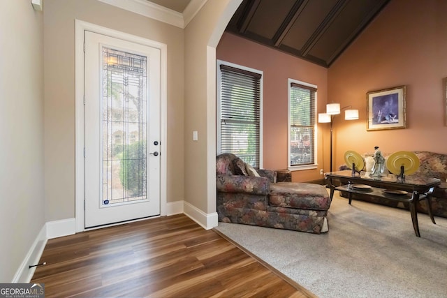 663 Warm Springs Ct, Loganville, GA 30052 - entrance foyer featuring arched walkways, wood finished floors, crown molding, and vaulted ceiling
