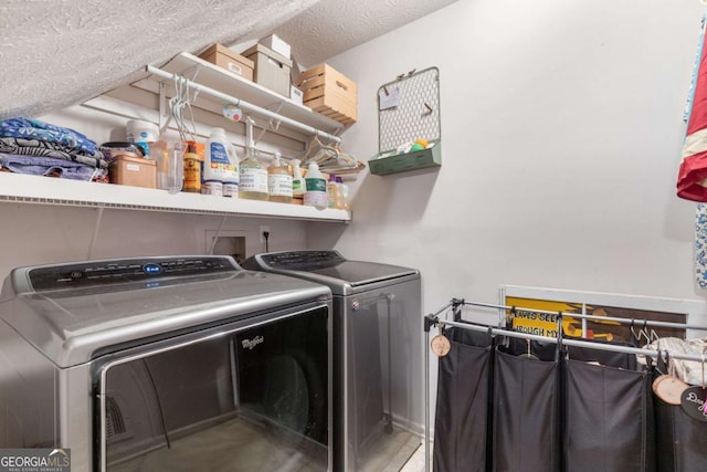 washroom with independent washer and dryer and a textured ceiling