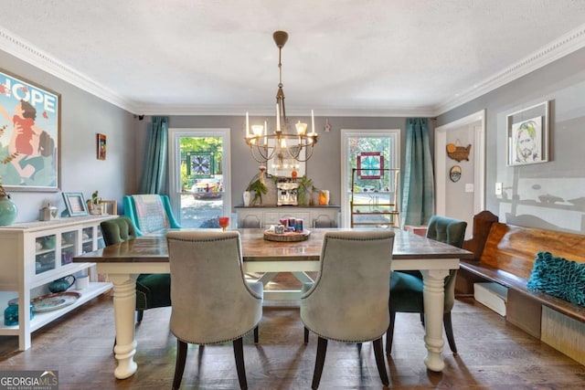 dining area with a chandelier, crown molding, wood finished floors, and a textured ceiling