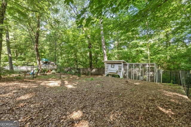 fenced backyard with exterior structure and an outbuilding
