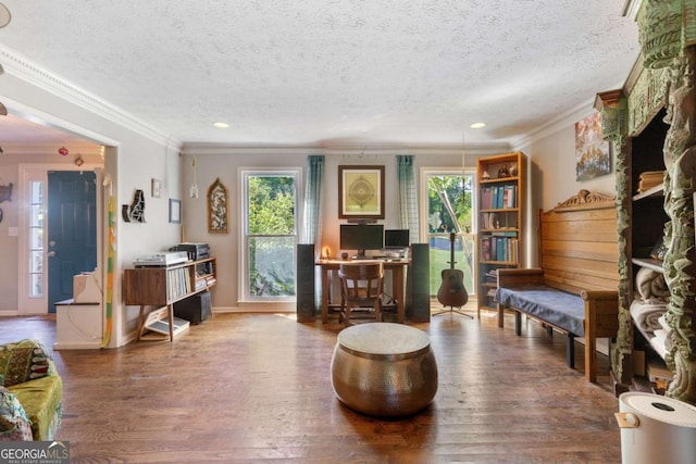 living room with crown molding, wood finished floors, plenty of natural light, a textured ceiling, and baseboards