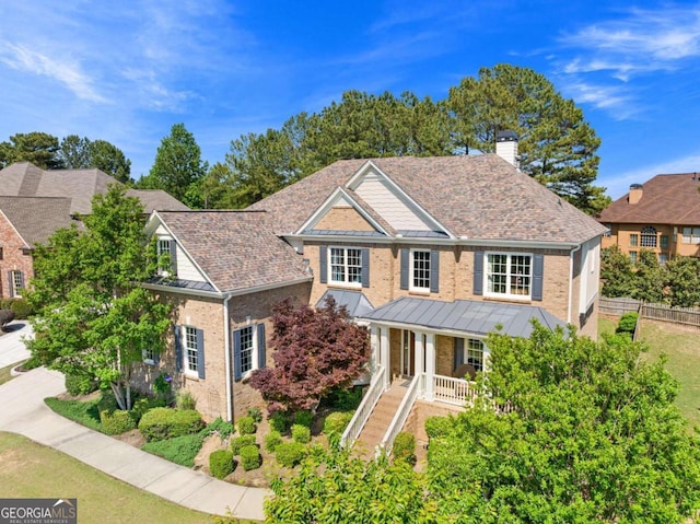 3456 Glen Mist Pl, Dacula, GA 30019 - view of front facade featuring a standing seam roof, covered porch, a chimney, and brick siding