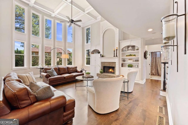 3456 Glen Mist Pl, Dacula, GA 30019 - living area with a towering ceiling, dark wood-style floors, a fireplace, baseboards, and beamed ceiling