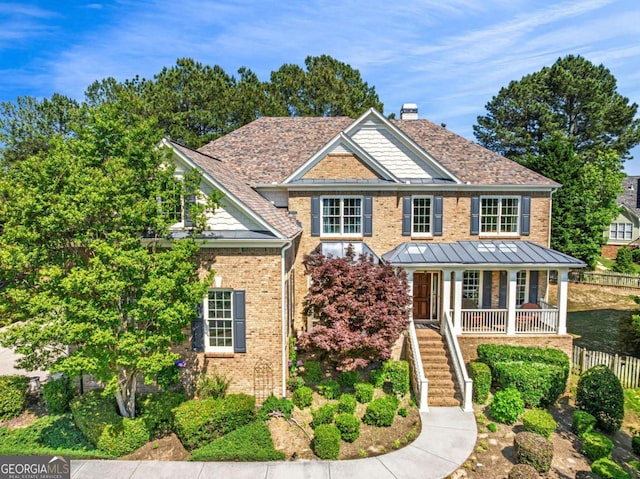 3456 Glen Mist Pl, Dacula, GA 30019 - view of front of property with brick siding, covered porch, a chimney, stairway, and a standing seam roof