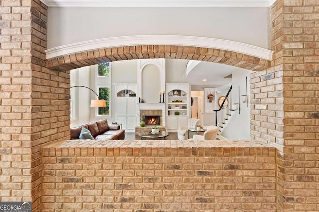 3456 Glen Mist Pl, Dacula, GA 30019 - bar area with a fireplace, stairway, and brick wall