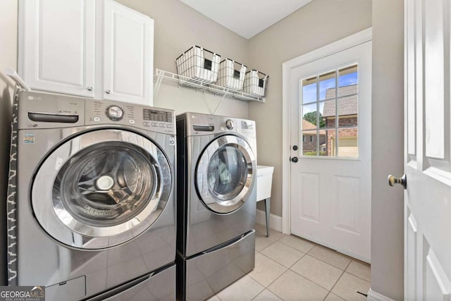 3456 Glen Mist Pl, Dacula, GA 30019 - laundry area with separate washer and dryer, cabinet space, baseboards, and light tile patterned flooring