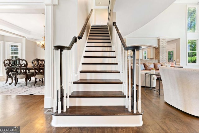 3456 Glen Mist Pl, Dacula, GA 30019 - stairs featuring wood finished floors, plenty of natural light, a towering ceiling, ornamental molding, and a chandelier