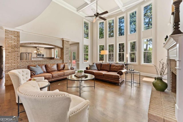 3456 Glen Mist Pl, Dacula, GA 30019 - living area with healthy amount of natural light, ceiling fan, a high ceiling, coffered ceiling, and beamed ceiling