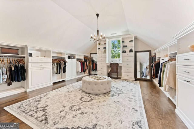 3456 Glen Mist Pl, Dacula, GA 30019 - spacious closet featuring dark wood finished floors, vaulted ceiling, and a chandelier
