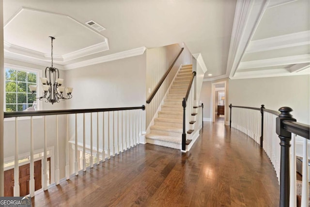 3456 Glen Mist Pl, Dacula, GA 30019 - stairway with a chandelier, wood finished floors, ornamental molding, a raised ceiling, and baseboards