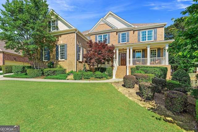 3456 Glen Mist Pl, Dacula, GA 30019 - view of front of house featuring brick siding, a front lawn, and covered porch