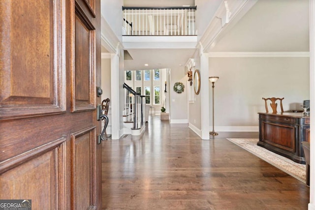 3456 Glen Mist Pl, Dacula, GA 30019 - entryway featuring stairs, dark wood-style flooring, baseboards, ornamental molding, and a towering ceiling
