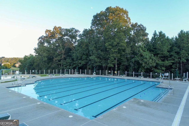 3456 Glen Mist Pl, Dacula, GA 30019 - community pool featuring a patio and view of wooded area