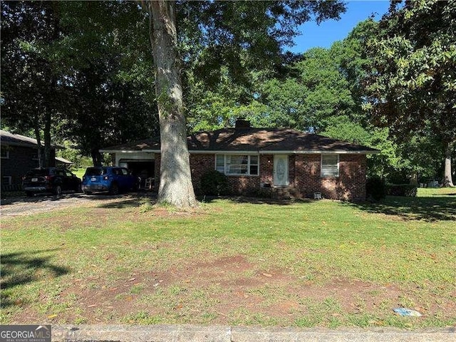 view of front of property with a front yard and brick siding