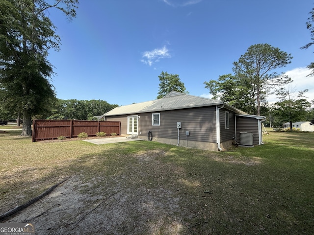 back of house featuring a patio, french doors, central air condition unit, and metal roof