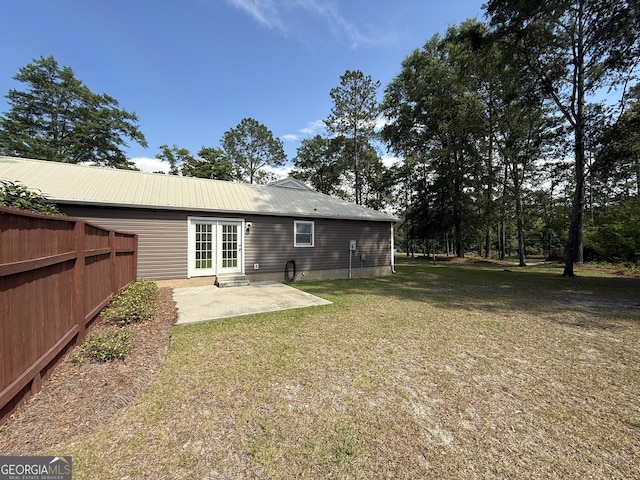back of property with a patio and metal roof