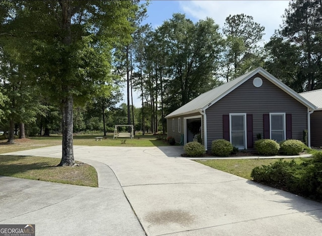 view of home's community with driveway and a lawn