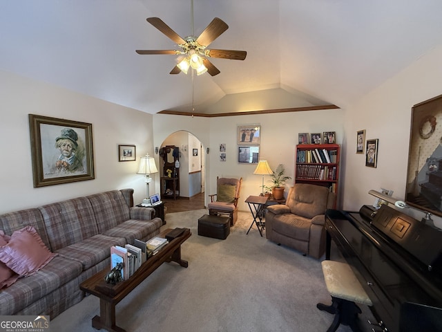 living area featuring carpet flooring, arched walkways, a ceiling fan, and vaulted ceiling